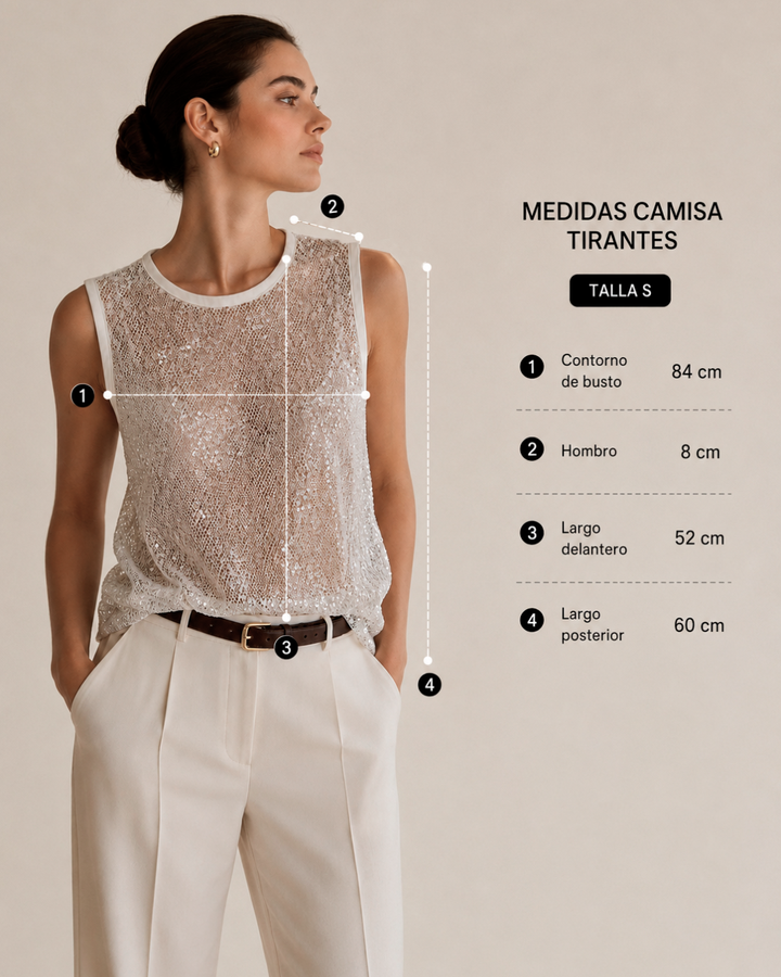 Blusa femenina en maya bordada con lentejuelas color blanco, diseño semitransparente sin mangas y cuello redondo. Estilo elegante y sofisticado para ocasiones especiales.